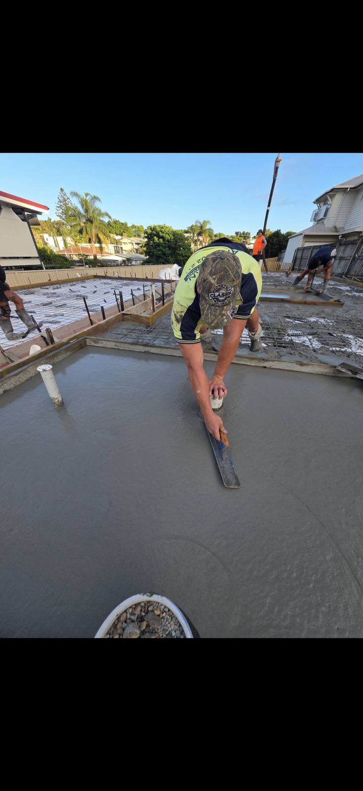 Edge trowelling near a pipe penetration on a slab pour