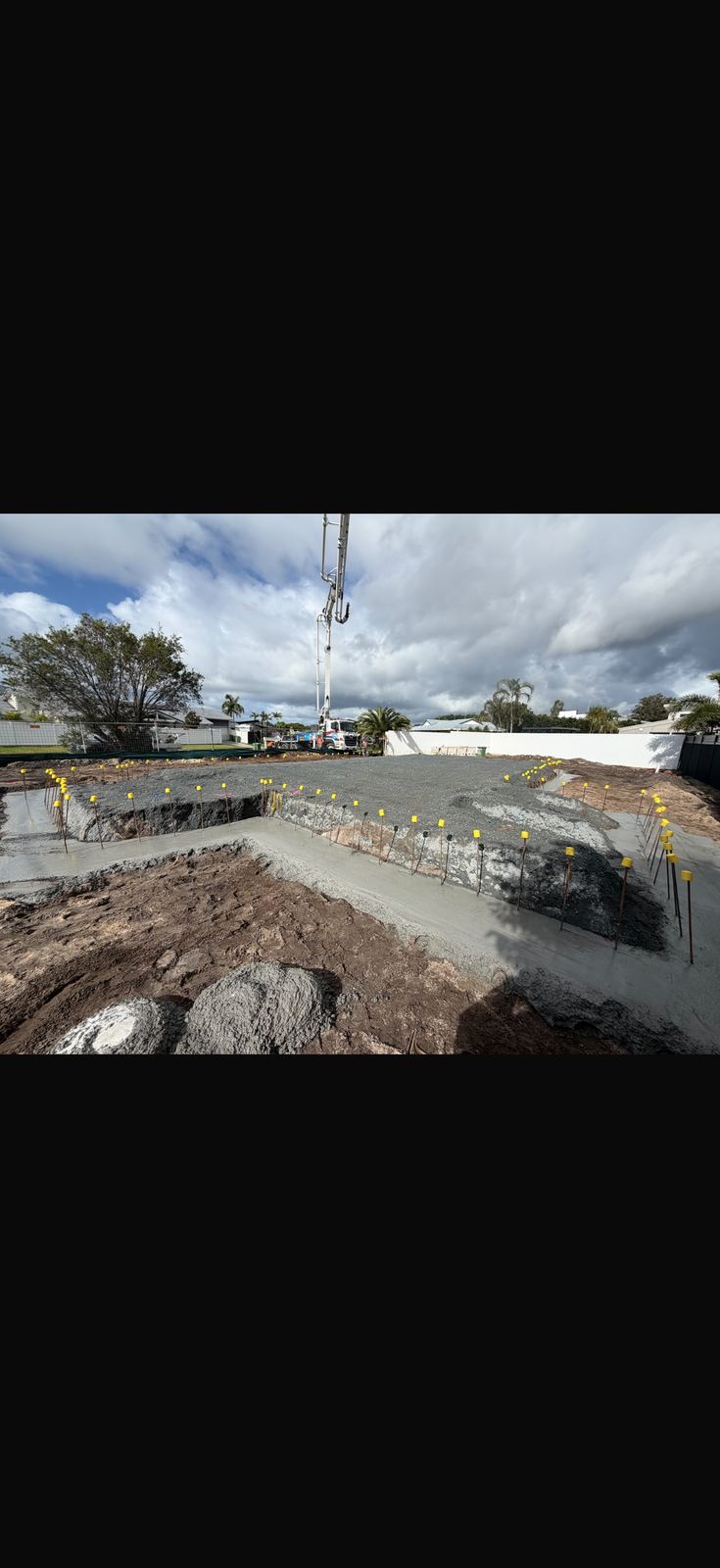 House slab pour with concrete pump on residential block