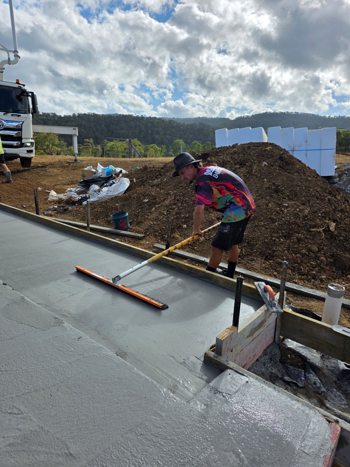Bull float finishing on a rural driveway pour