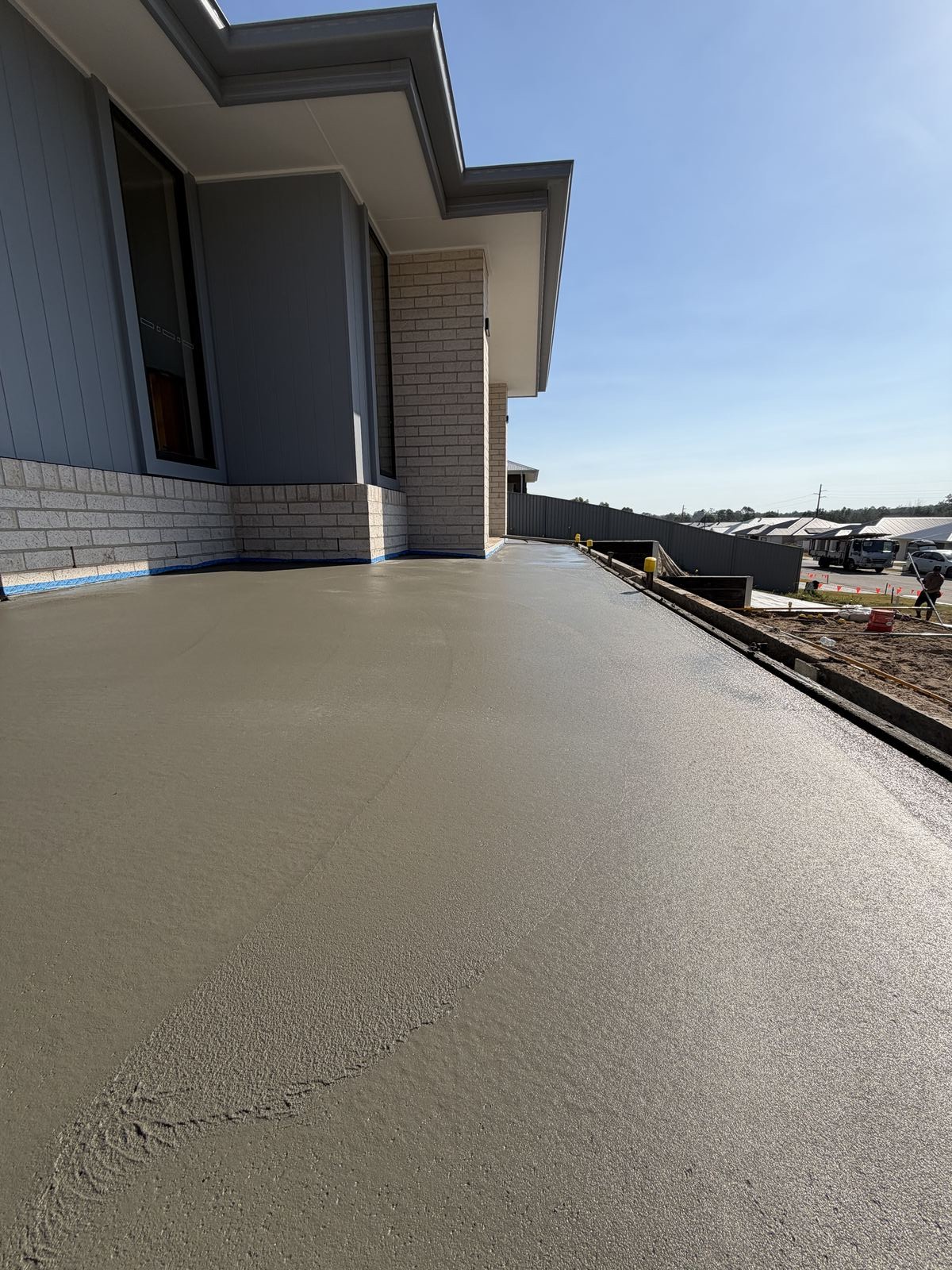 Exposed aggregate alfresco patio beside new home