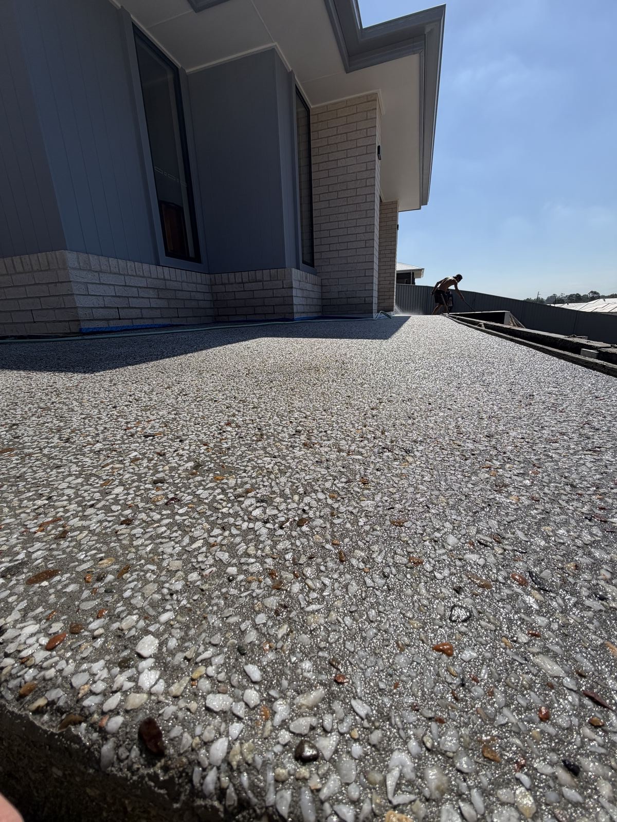 Close-up of exposed aggregate finish being hosed off