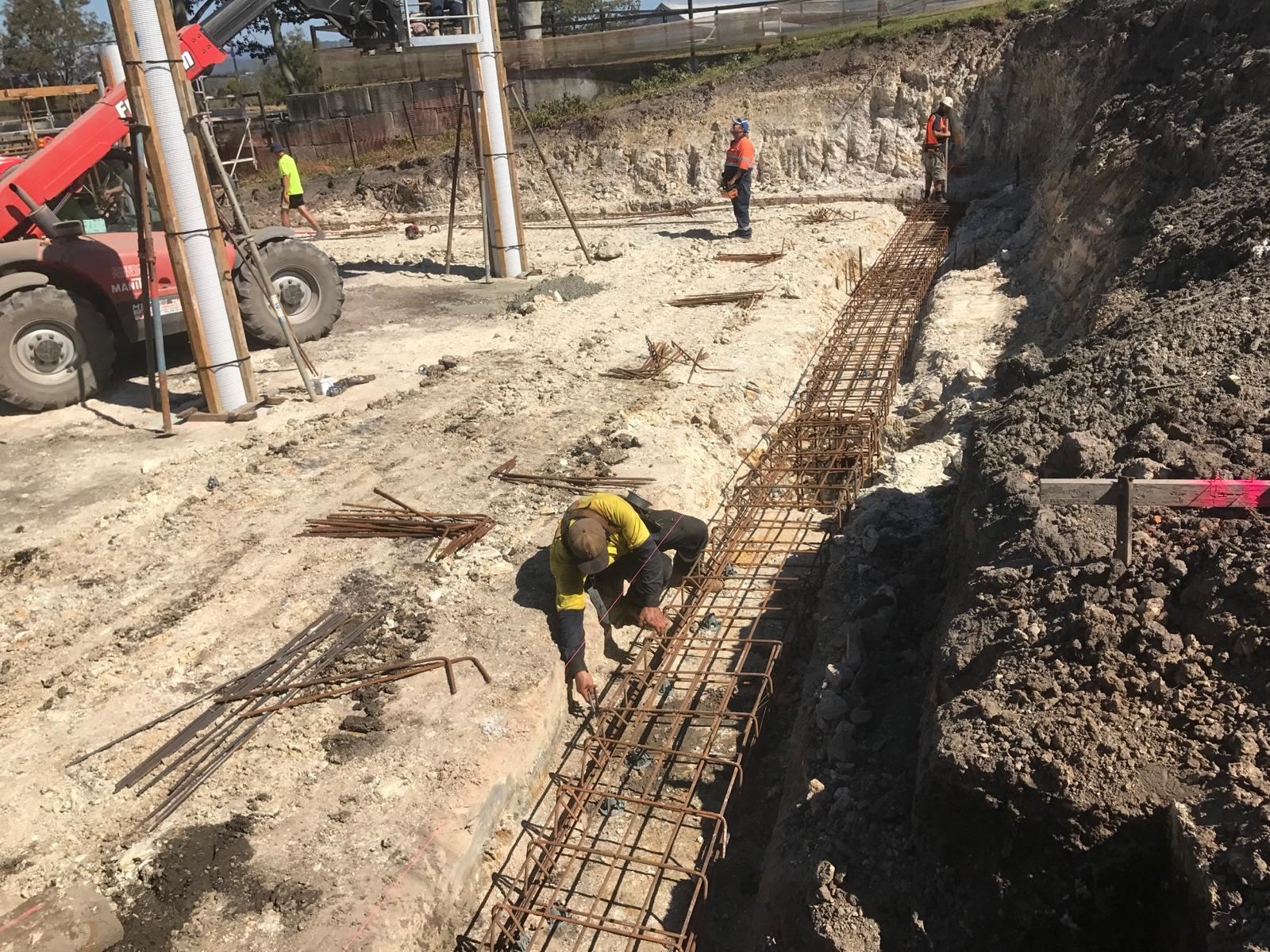 Footing trench excavation and reinforcement on a rural block