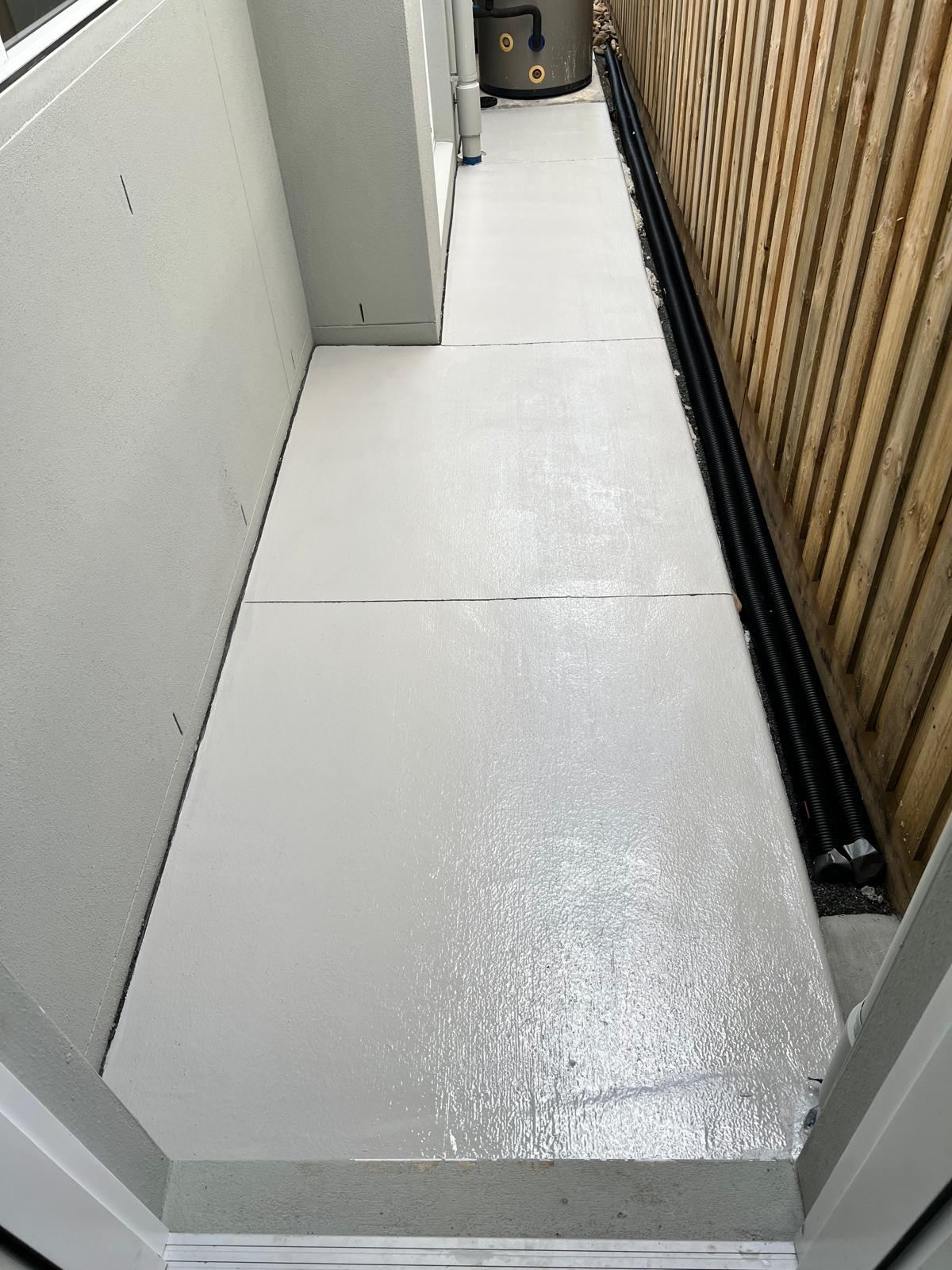 Sealed concrete path alongside a home
