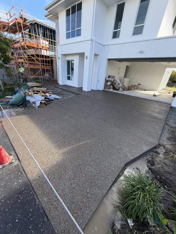 Exposed aggregate driveway leading to garage