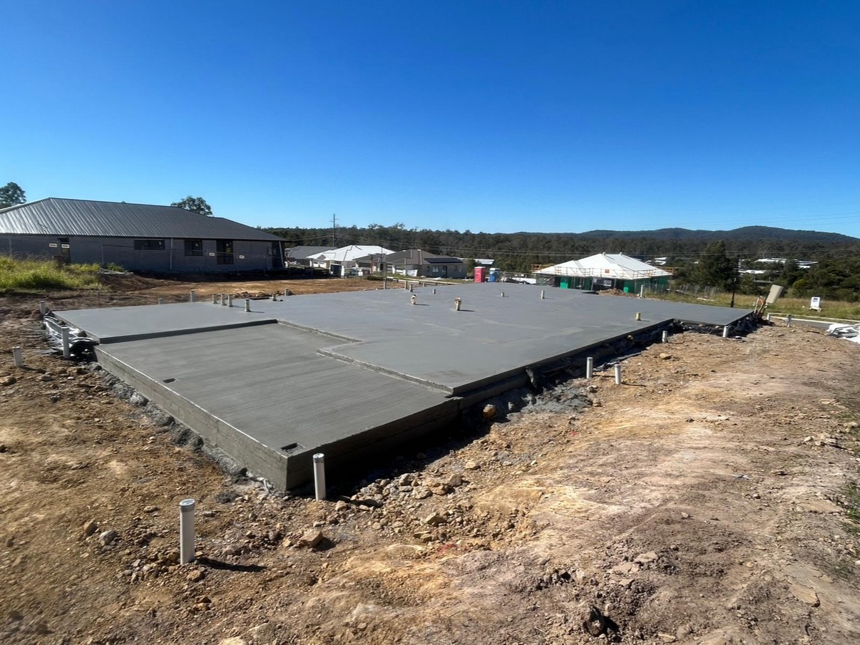 Completed house slab with steps, blue sky and distant hills