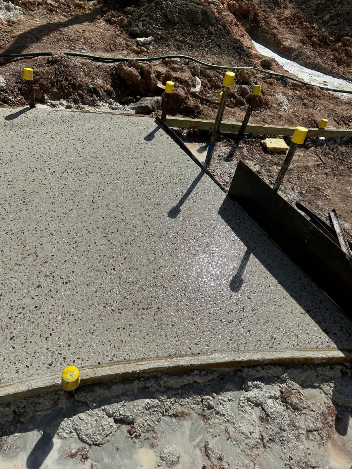 Overhead view of a curved exposed aggregate path being poured